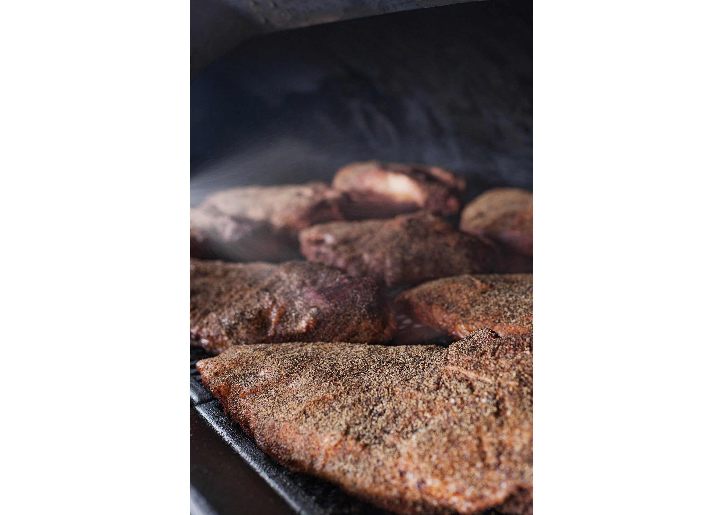 Cooked meat resting inside a cast iron grill.