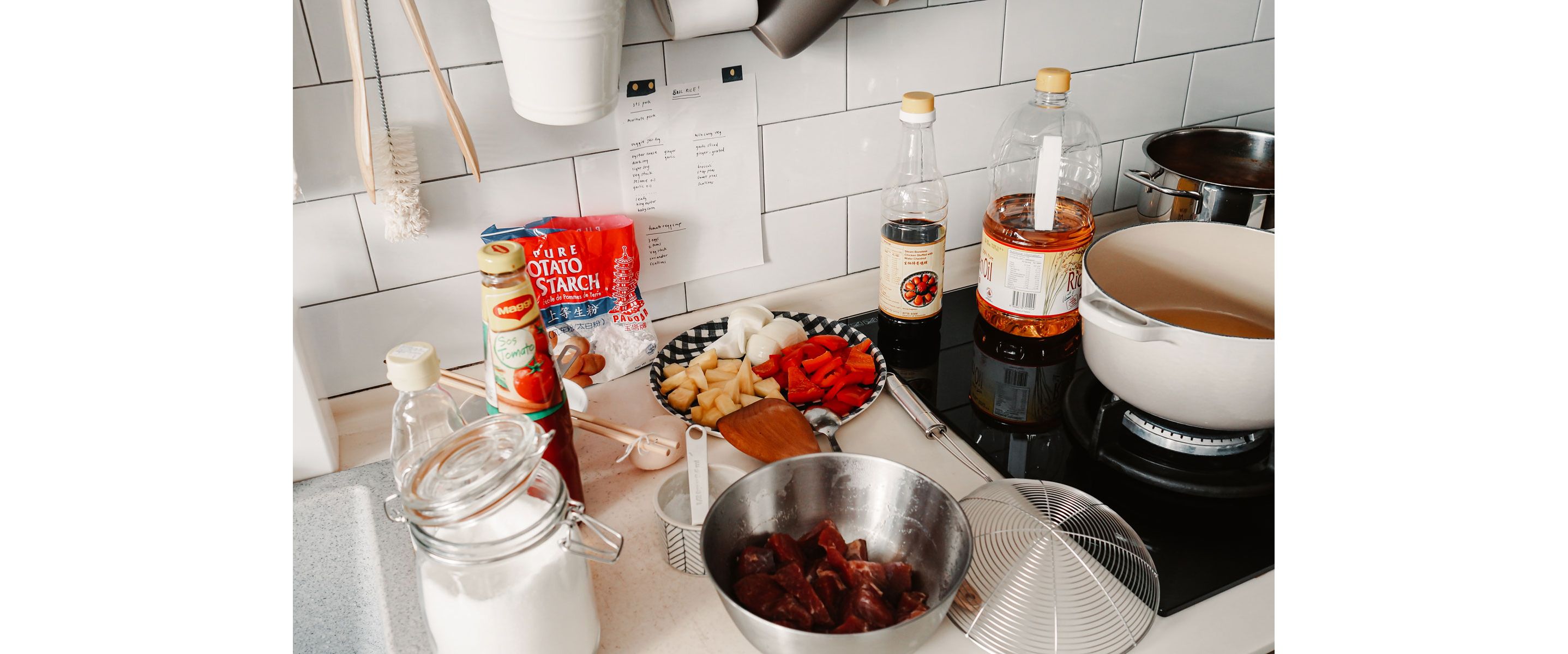 A countertop scattered with ingredients for sweet and sour pork.