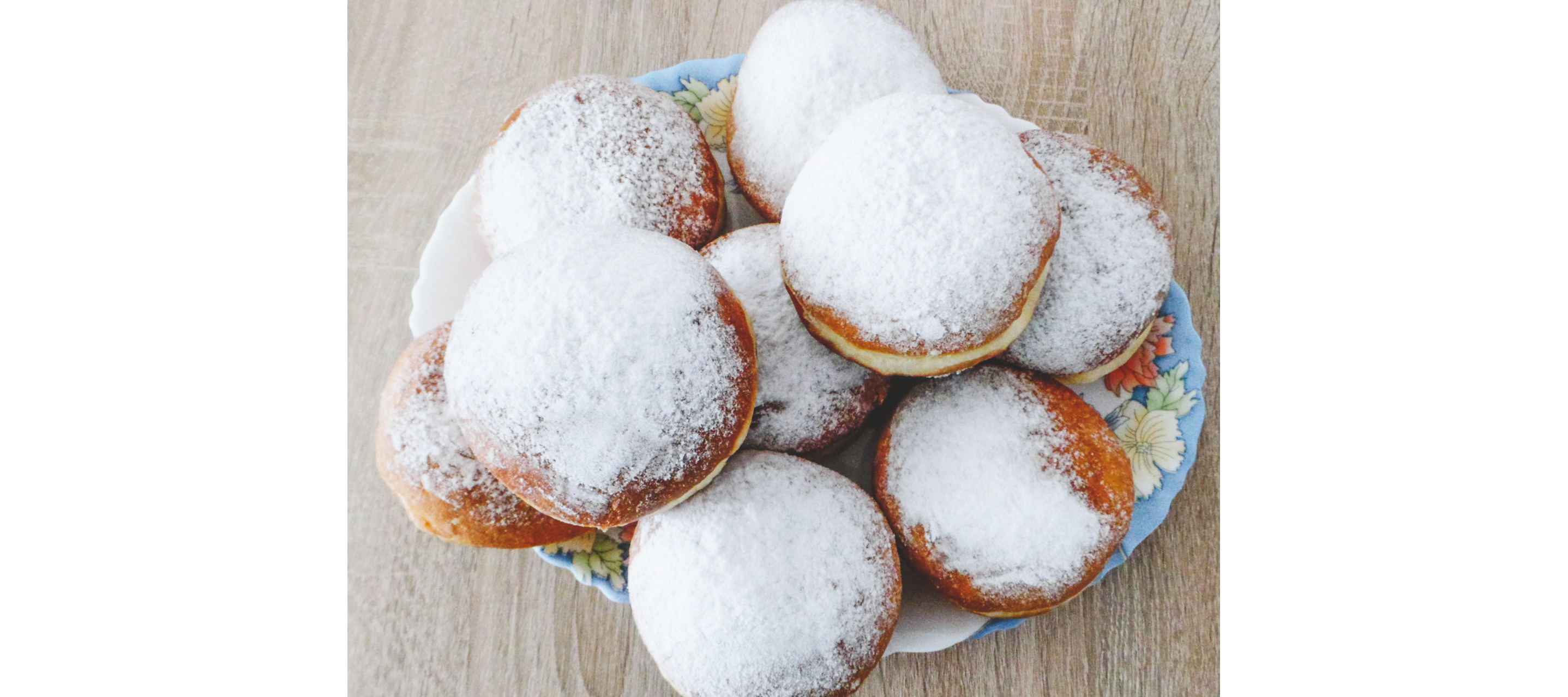A large plate overwhelmed with delicious Paczki.