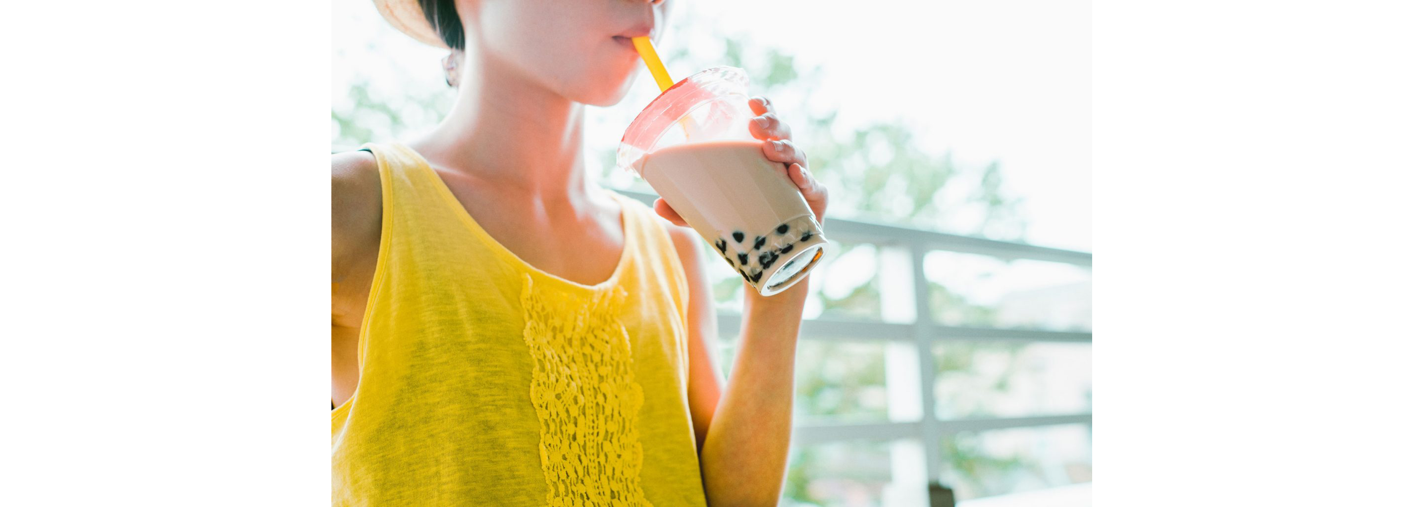 A person happily drinking boba tea.