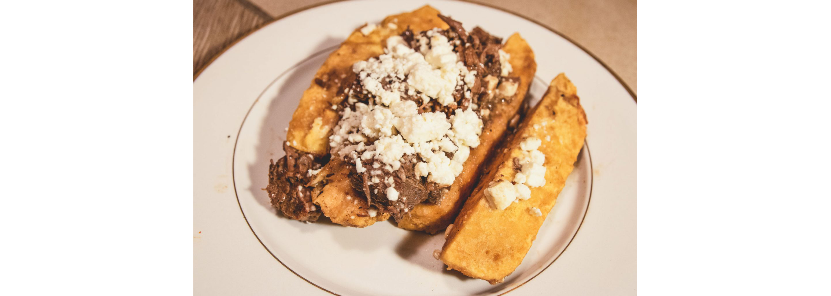 A plate of smoked sweet potato with fresh garnish and toppings.