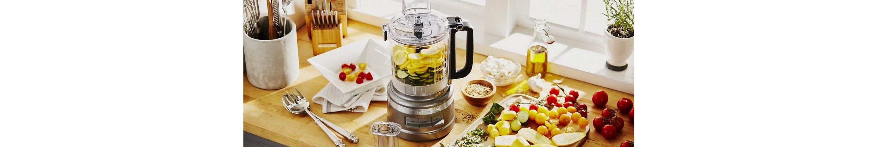 Silver food processor on counter with ingredients