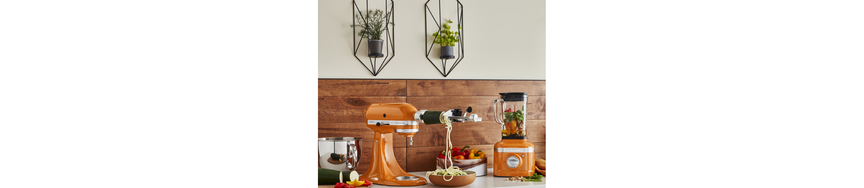 Stand Mixer in Honey spiralizing zucchini beside a matching blender