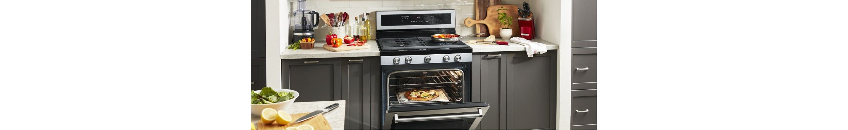 Grey cabinetry surrounding an open KitchenAid® Range