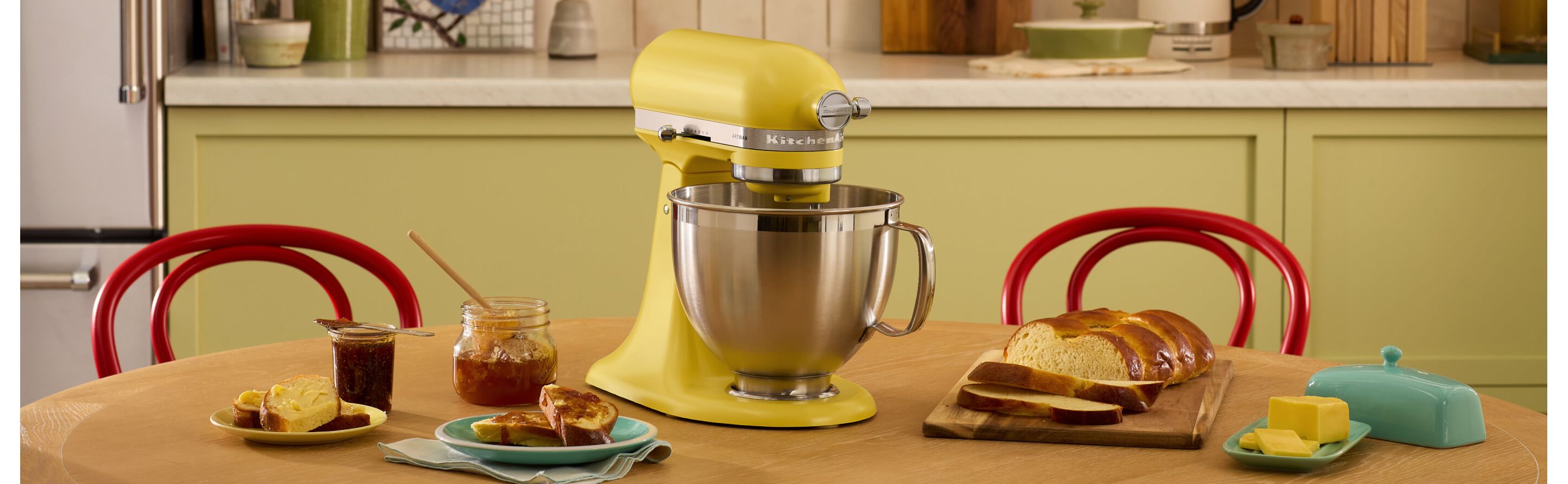 The Butter Stand Mixer surrounded by jams, breads and butter.