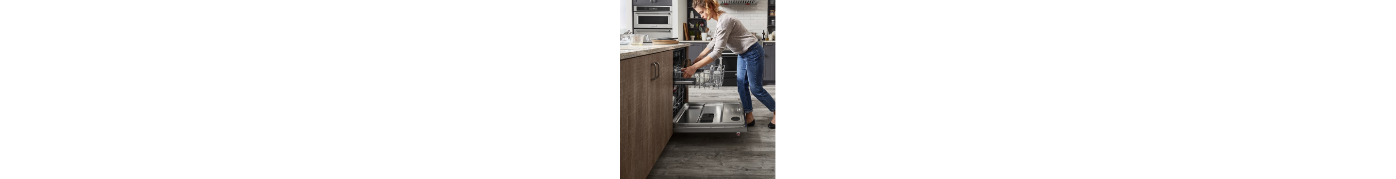 A person unloading a dishwasher in a kitchen