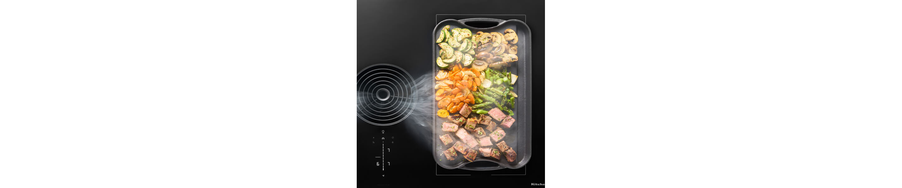 Food cooking on a griddle resting on the bridge element of an electric cooktop