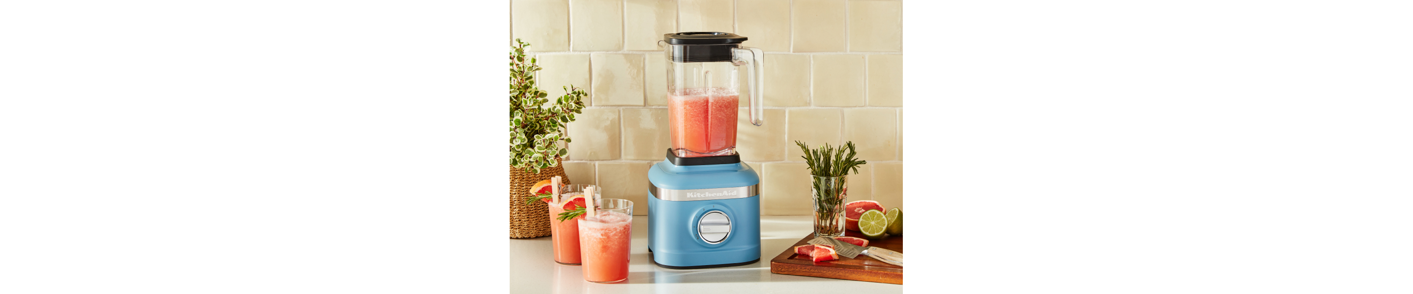A KitchenAid® blender with a smoothie mixture on a modern kitchen counter.