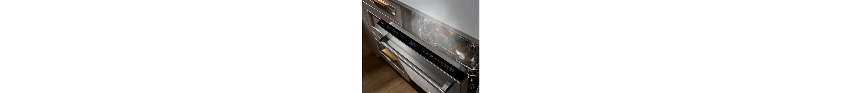 Top view of a slightly ajar front control panel dishwasher door with steam coming out