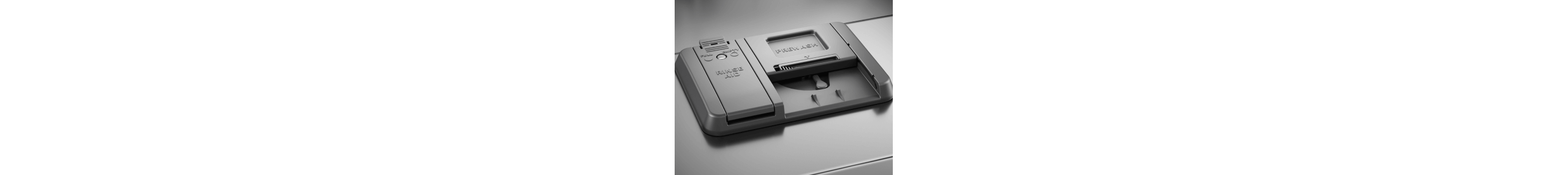 Closed dishwasher detergent dispenser with a slot for prewash and rinse aid