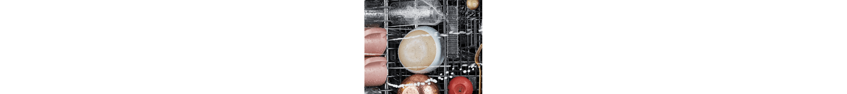 Water spraying on wet dishes loaded in a dishwasher rack