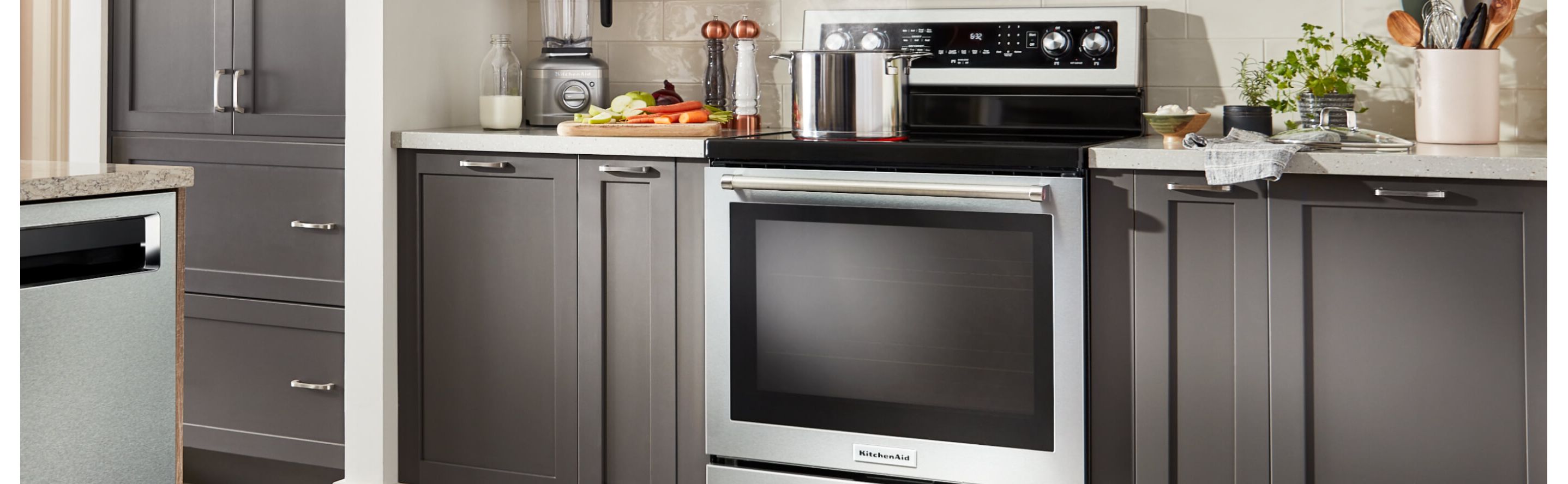 Stainless steel range in a kitchen with dark cabinets