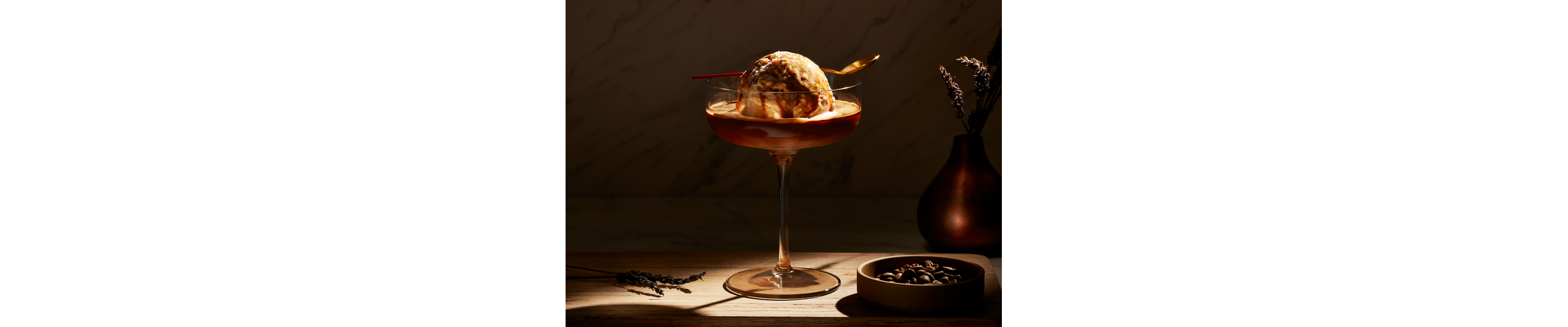 An affogato in a glass serving dish