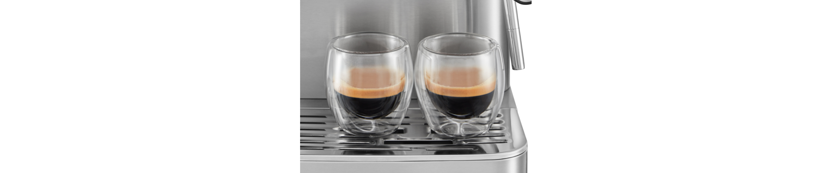 Two ristretto shots resting on the base of an espresso machine