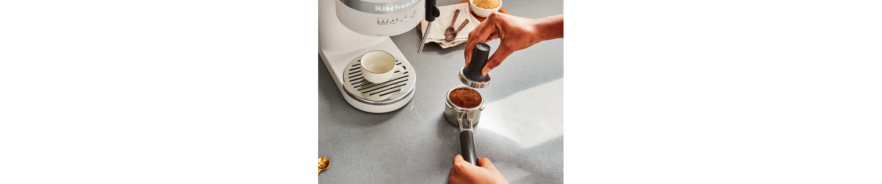 Person tamping espresso in a portafilter