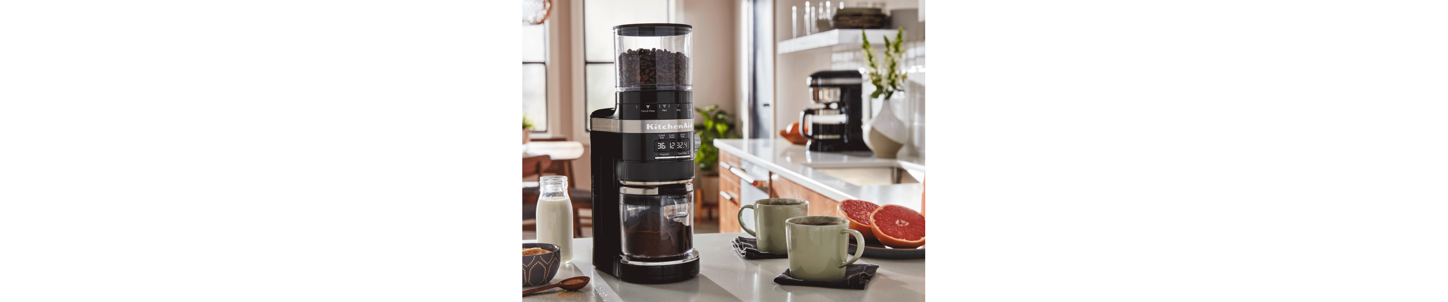 KitchenAid® coffee grinder next to two mugs