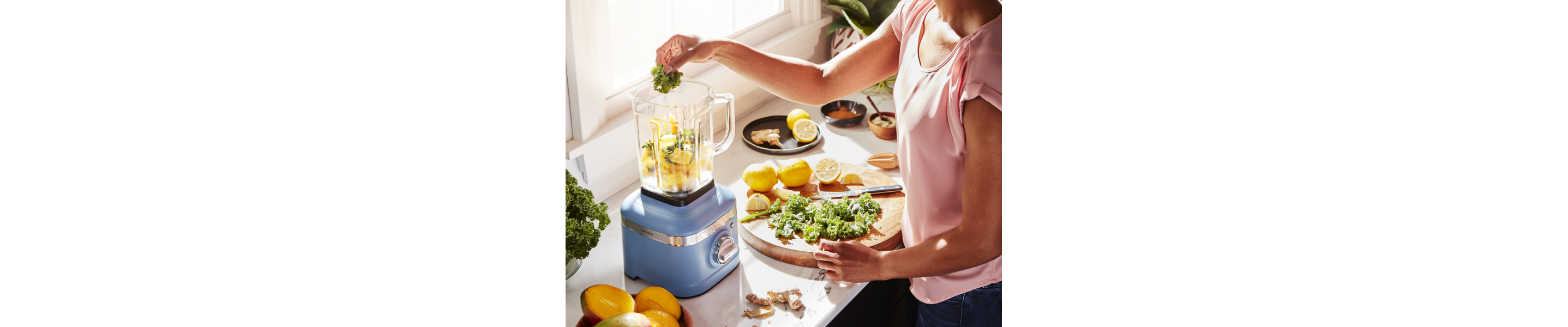 Lemons and herbs being added to KitchenAid® blender