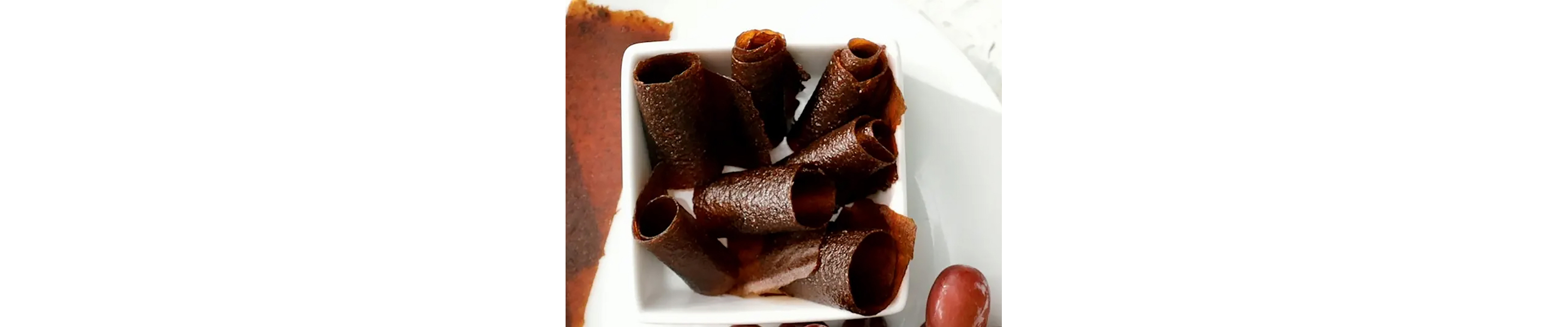 A dish of homemade rolled fruit leather.