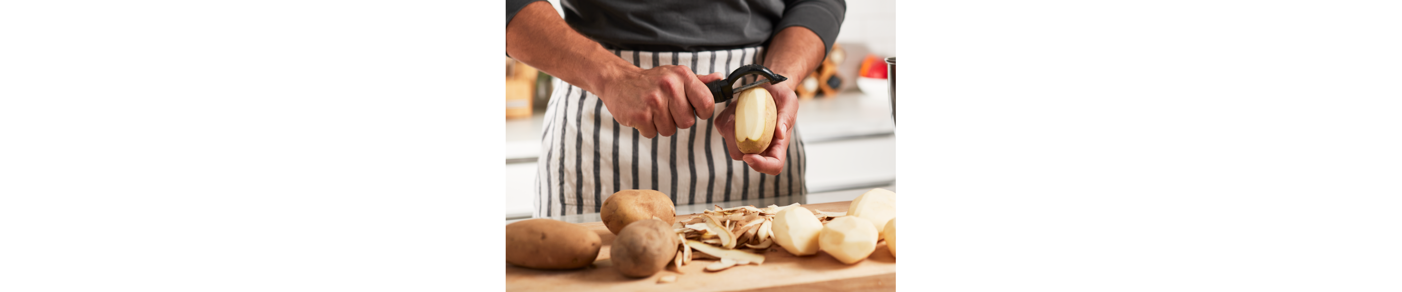 A man peeling potatoes.