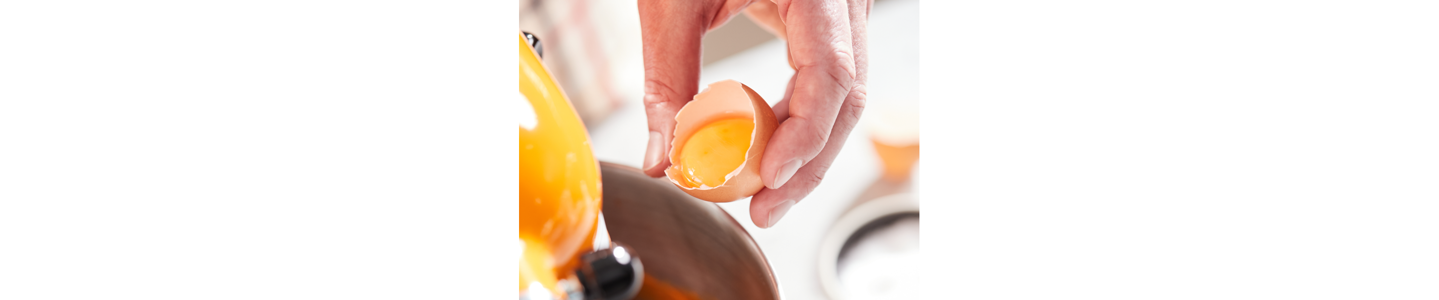 A person separating egg whites from the yolks.