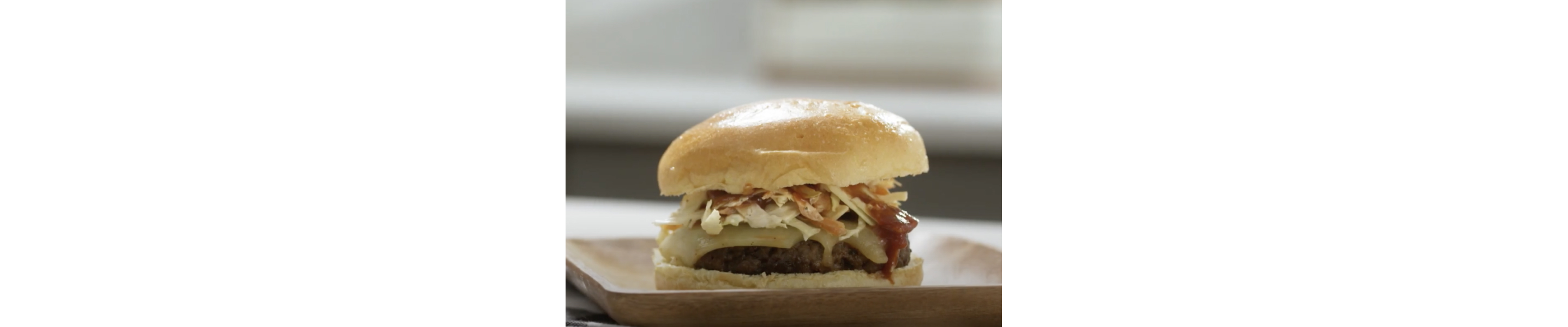 Cooked burger on a bun topped with coleslaw