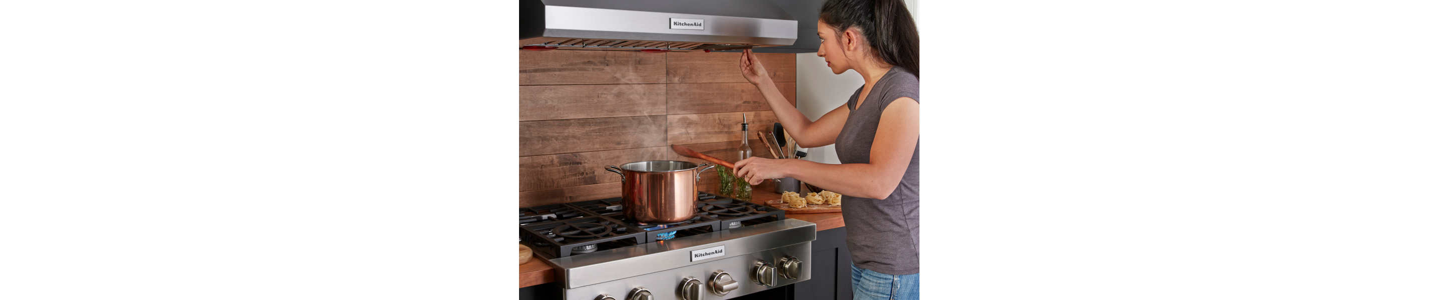 A saucepan boiling on a KitchenAid® cooktop