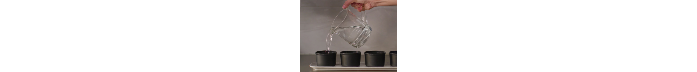 A pitcher pouring water into ice molds