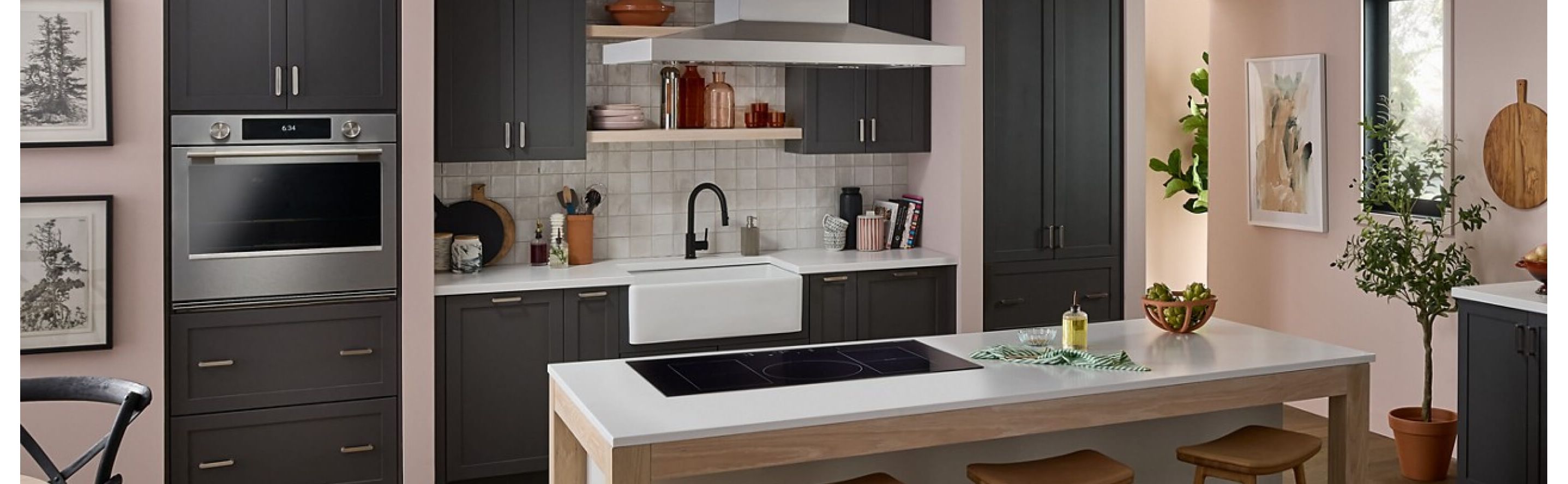 A neutral-toned kitchen with an induction cooktop set into an island