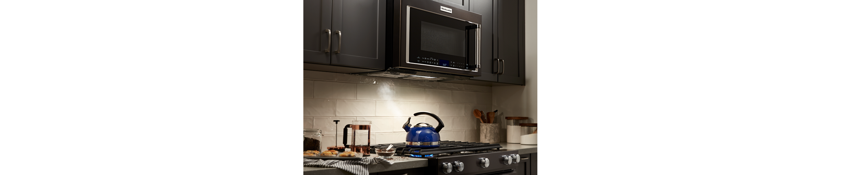 A KitchenAid® over-the-range microwave and oven in a modern kitchen.