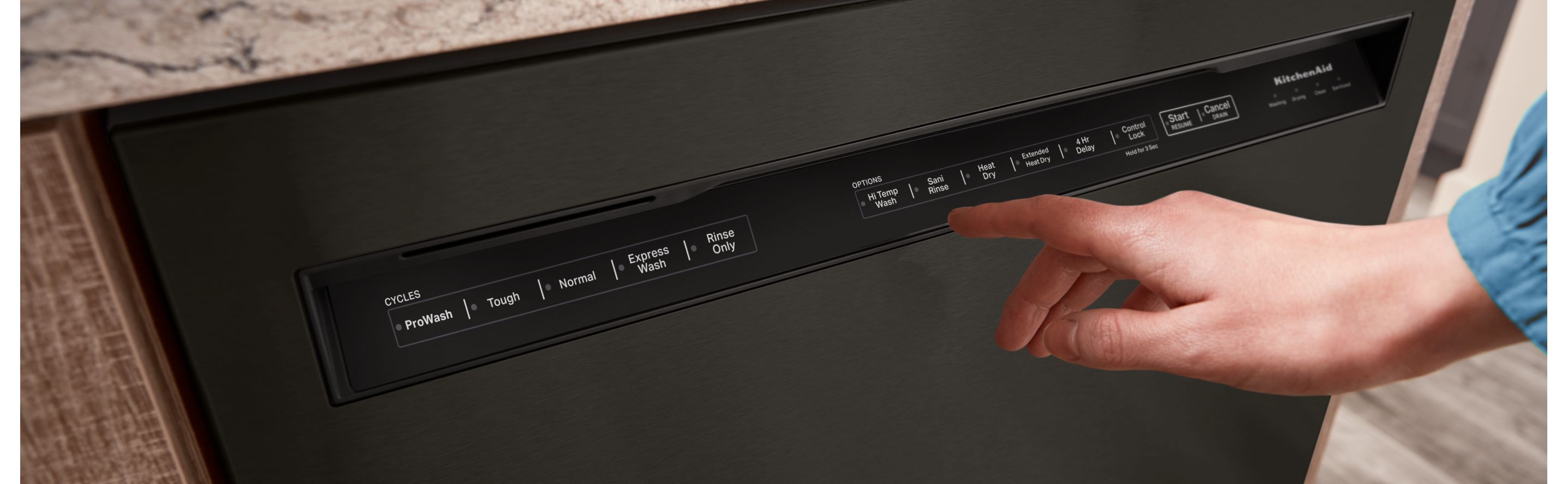 Person selecting settings on a KitchenAid® dishwasher