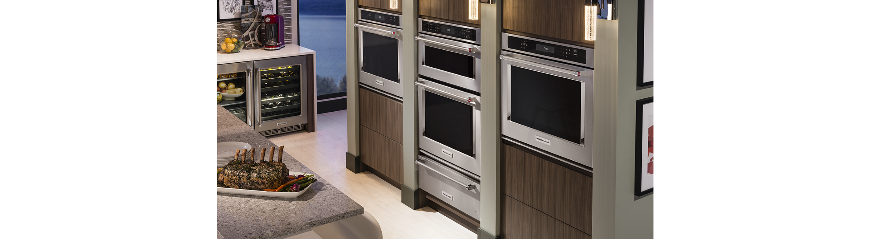 A double wall oven between two single wall ovens