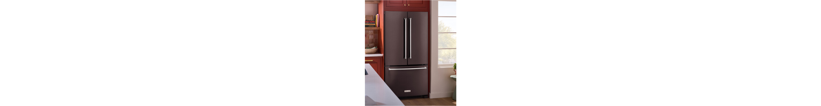 A KitchenAid® refrigerator surrounded by brown cabinetry