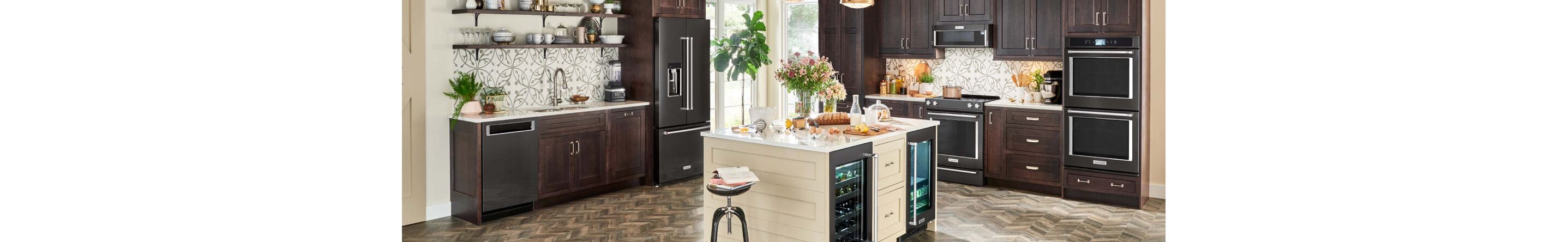 A large kitchen with an island and dark appliances