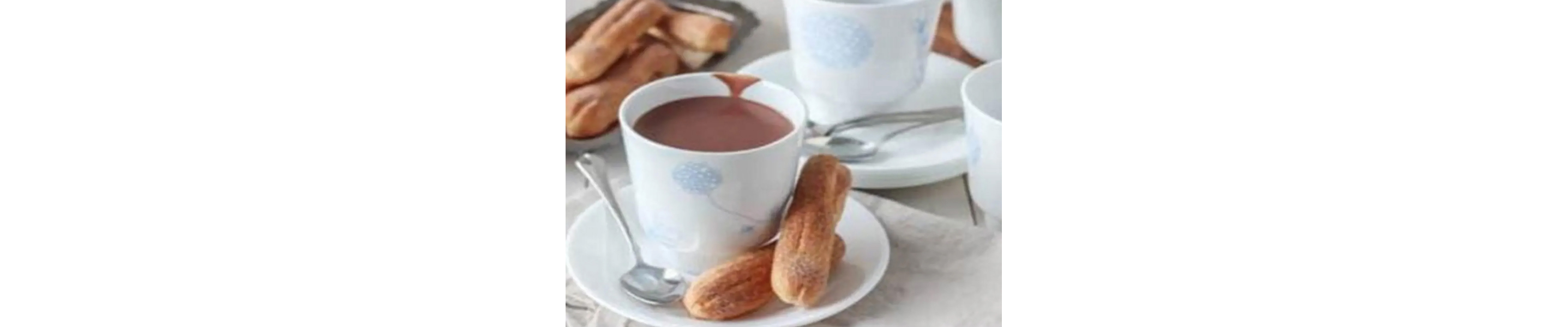 Eclairs next to a cup of coffee