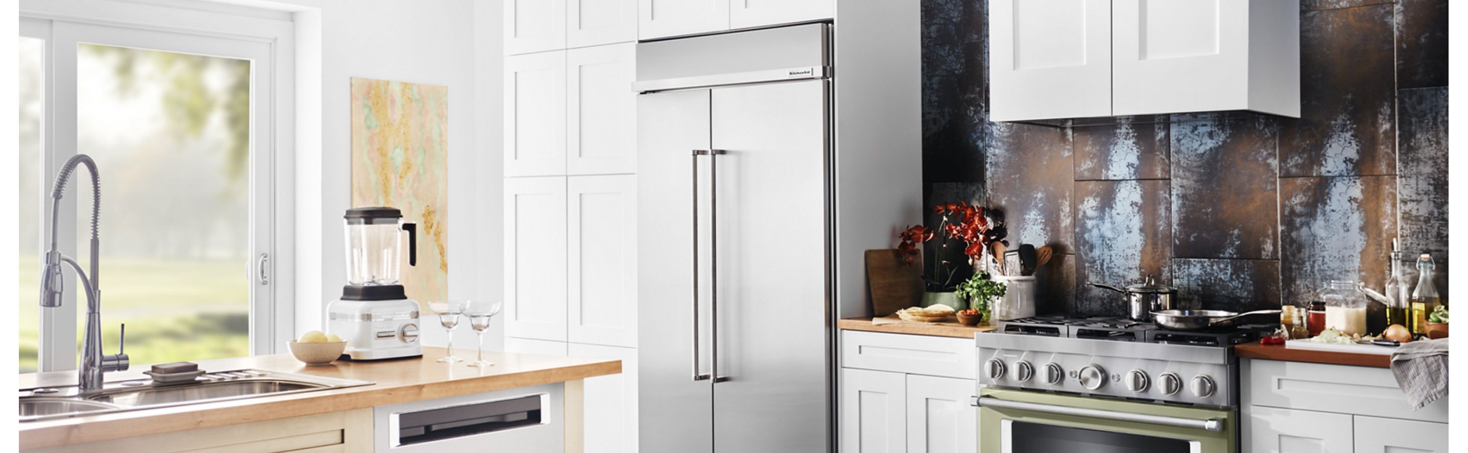 Built-in stainless steel KitchenAid® refrigerator in white cabinetry