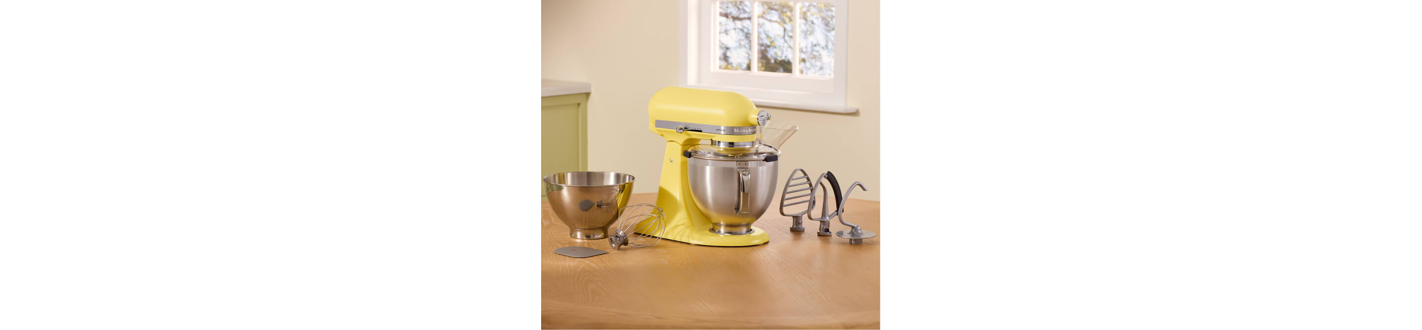 The Butter stand mixer alongside various beaters, bowls and dough hooks.