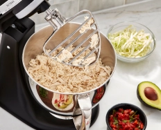 A pastry beater attachment on a stand mixer.