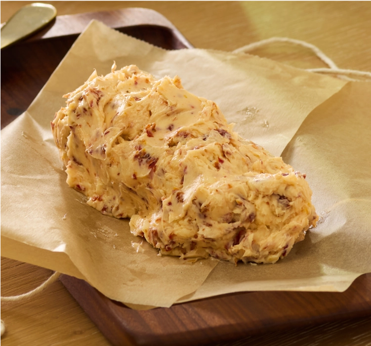 Freshly made compound butter on parchment paper.