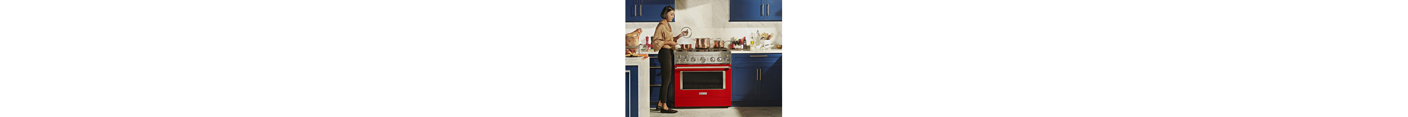 Person in front of a red kitchen range