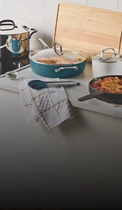 Dishes on a counter surrounded by teal cookware.