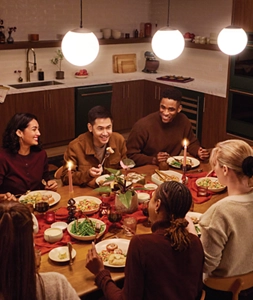 People gathering around the table at Room to Host