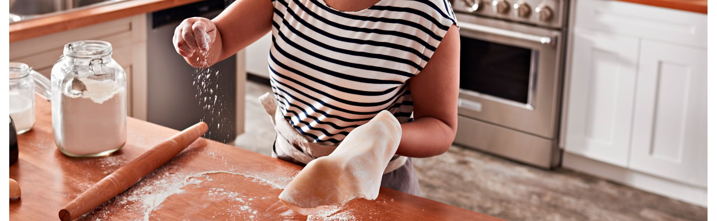Person rolling out dough on a countertop