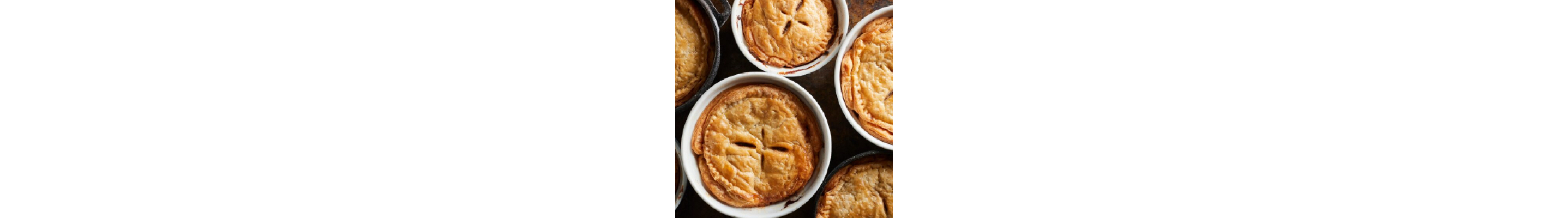 Several baked pie crusts in dishes