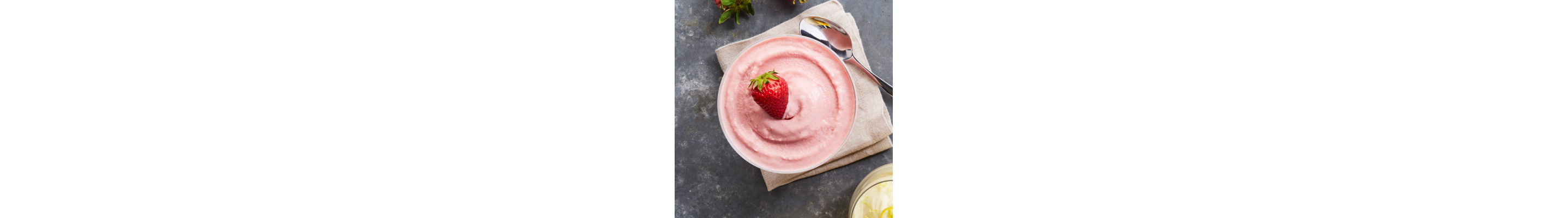 Bowl of Italian ice with strawberries and lemon