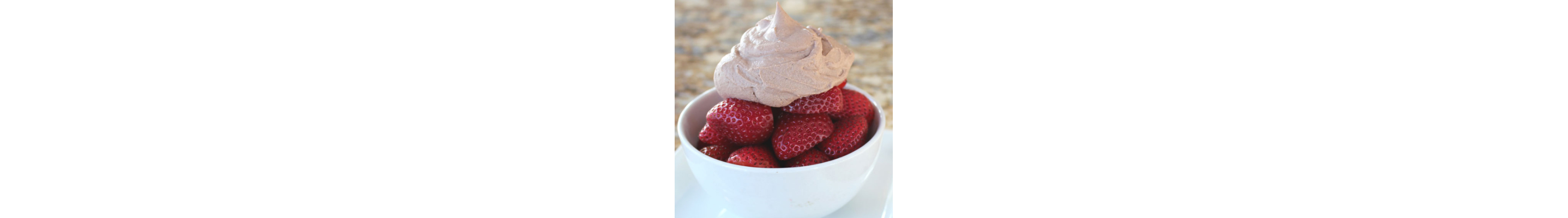 Sliced strawberries topped with chocolate whipped cream