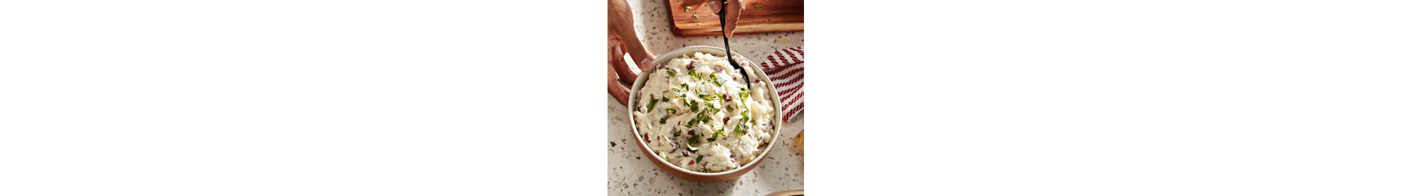 Bowls of red-skinned mashed potatoes and roasted garlic