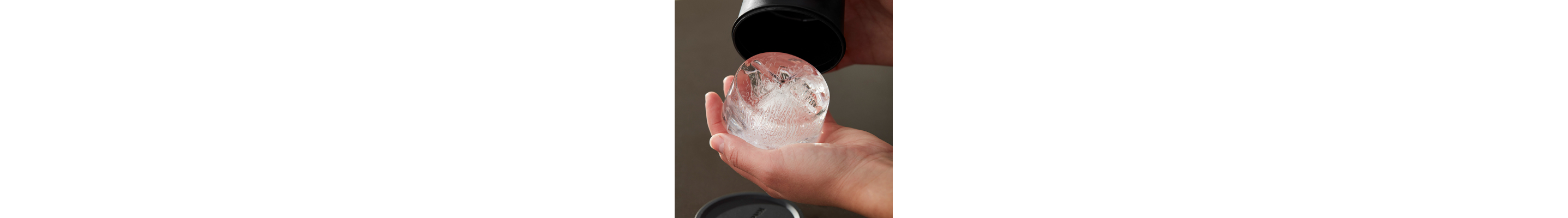 A person removing ice from an ice mold.