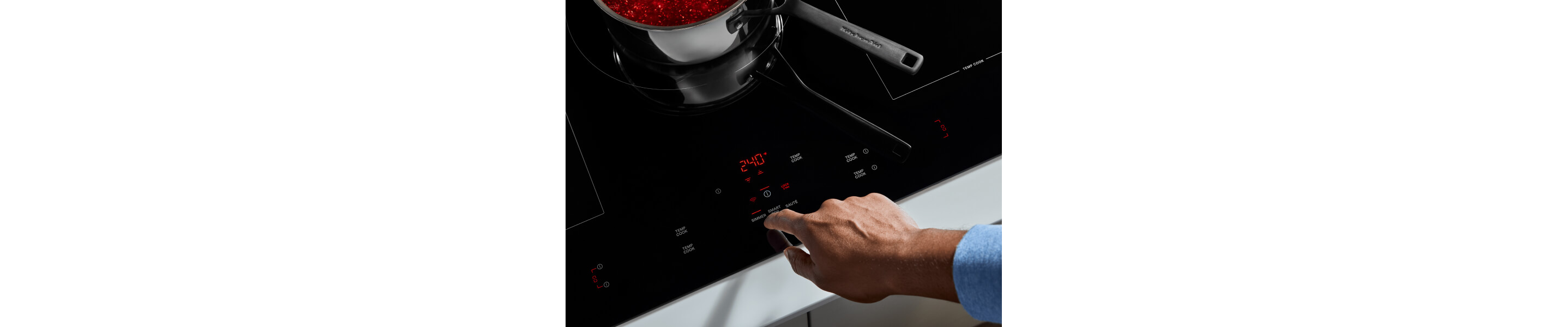A finger selecting a KitchenAid® induction cooktop feature