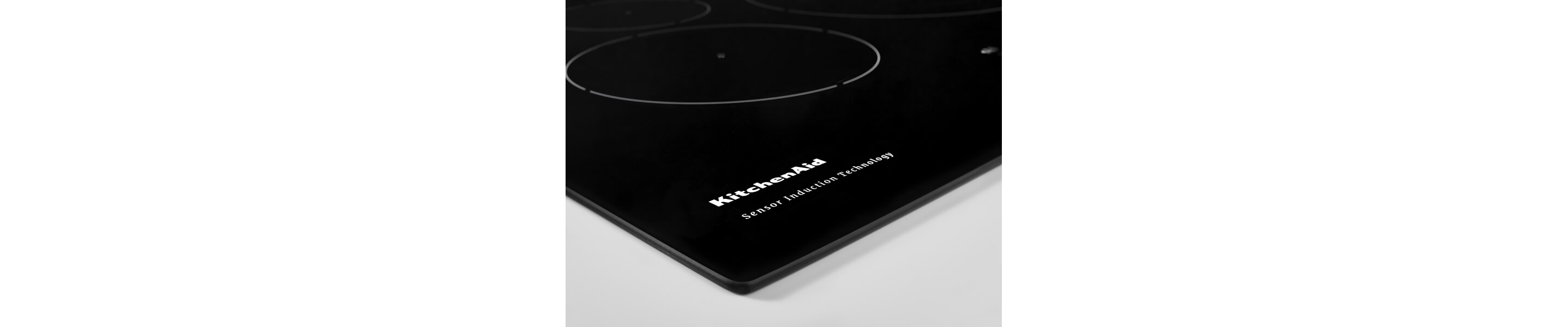 Close-up of KitchenAid brand writing on an induction cooktop