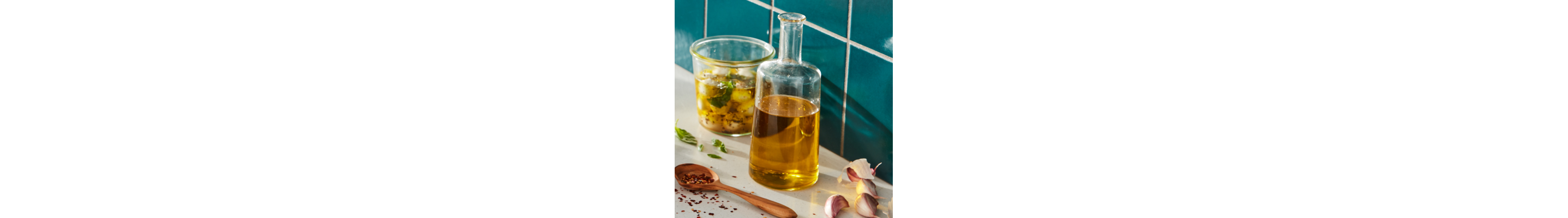 Oil in cruet with herbs and mozzarella balls